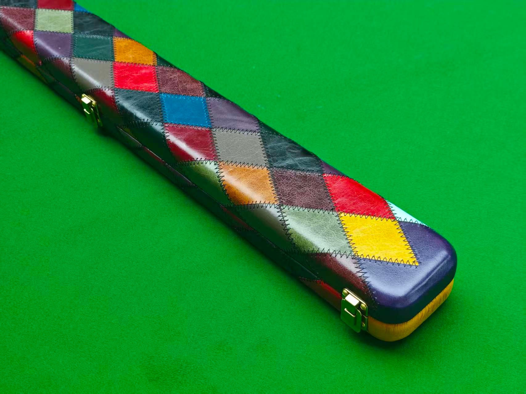 Multicoloured patchwork leather cue case photographed on green cloth